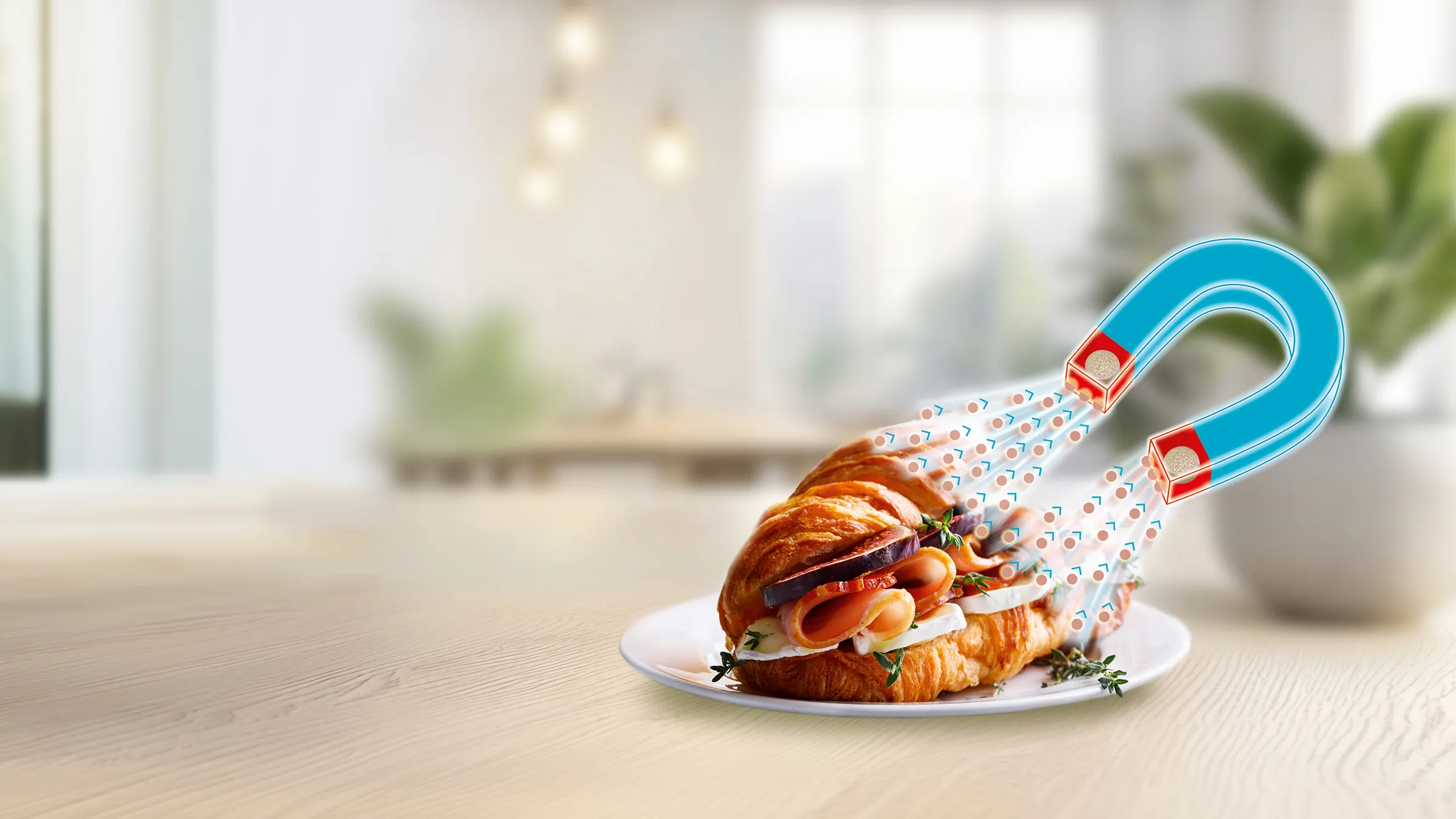 Croissant auf Teller mit grafischem Magneten, der Fett anzieht.